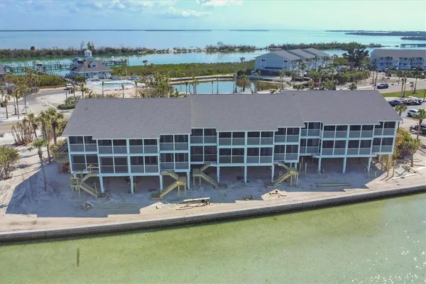 an aerial view of a house with a swimming pool and outdoor seating