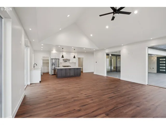 a view of kitchen and hall with wooden floor