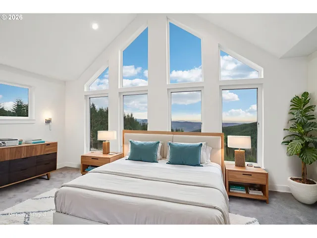 a bedroom with a large bed and a potted plant