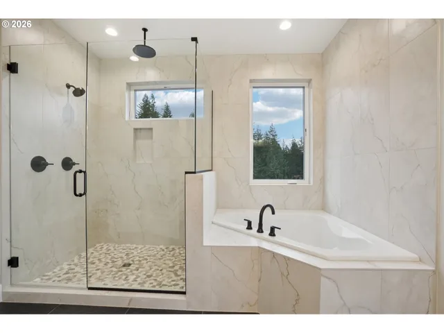 a bathroom with a granite countertop sink mirror and shower