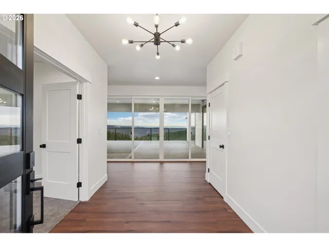 a view interior of a house with wooden floor and a ceiling fan