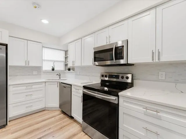 a kitchen with a sink stove and microwave