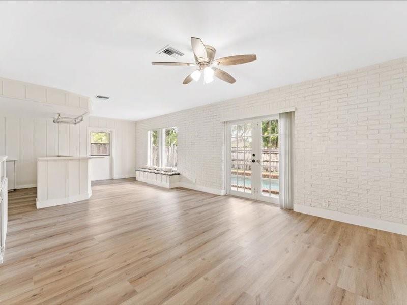 311 West Sample Road Deerfield Beach, FL 33064 - Photo 30 of 34 a view of an empty room with wooden floor and a window