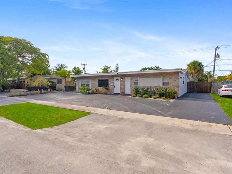 311 West Sample Road Deerfield Beach, FL 33064 - Photo 3 of 34 a view of house with outdoor space and street view