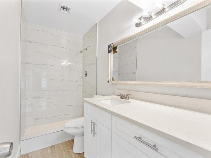 311 West Sample Road Deerfield Beach, FL 33064 - Photo 34 of 34 a bathroom with a sink a toilet and shower