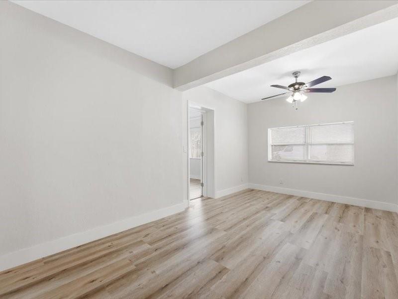 311 West Sample Road Deerfield Beach, FL 33064 - Photo 10 of 34 wooden floor in an empty room with a window