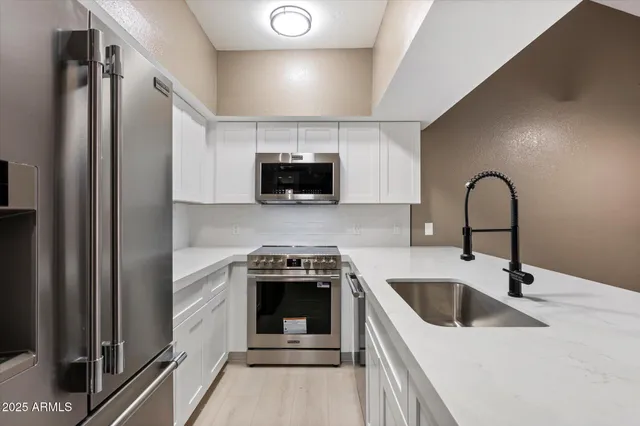 a kitchen with a sink a stove and refrigerator