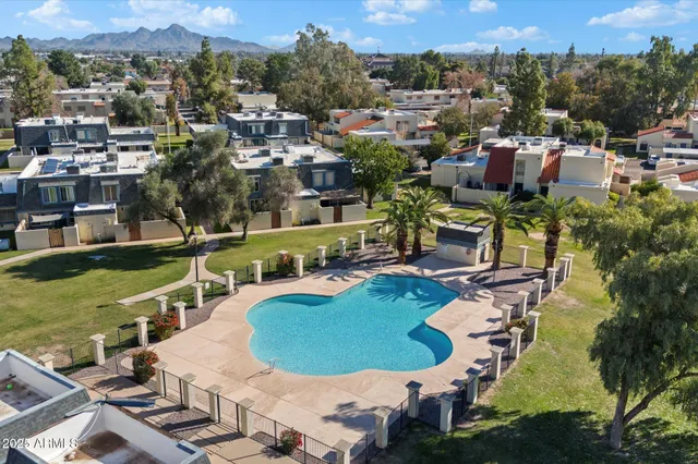 an aerial view of a house with a swimming pool outdoor seating and yard