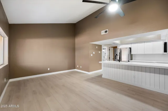 a view of a room with a flesh screen tv