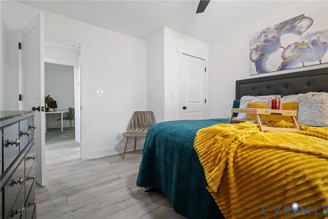 a bedroom with a bed and wooden floor