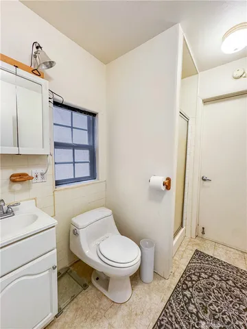 a bathroom with a toilet a sink and a shower