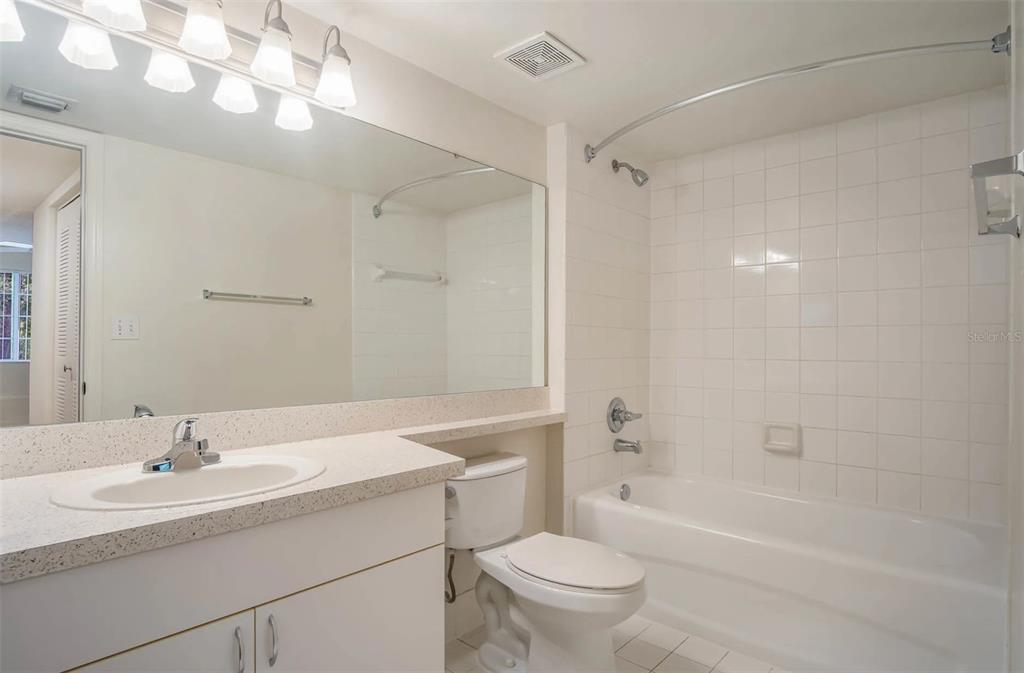 4248 Southeast Cove Lake Circle, Unit 3B06207 Stuart, FL 34997 - Photo 11 of 18 a bathroom with a sink a toilet and shower