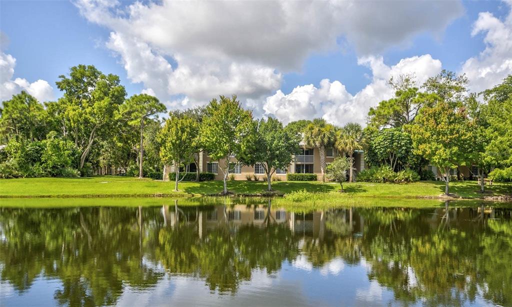 4248 Southeast Cove Lake Circle, Unit 3B06207 Stuart, FL 34997 - Photo 15 of 18 a view of a lake with a big yard