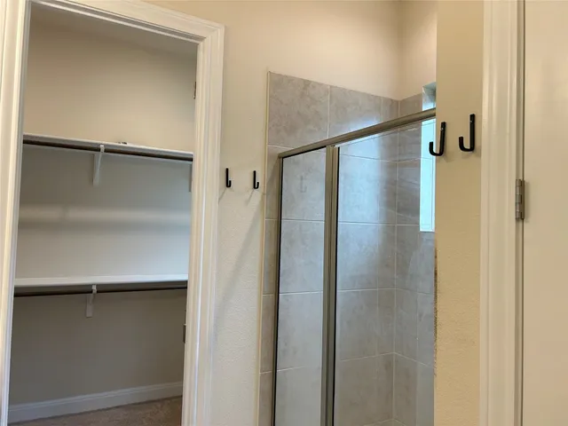 a bathroom with a glass shower door