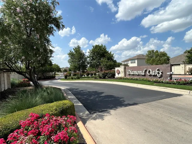 a view of street with houses and trees in the background
