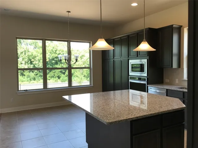 a kitchen with a table and chairs