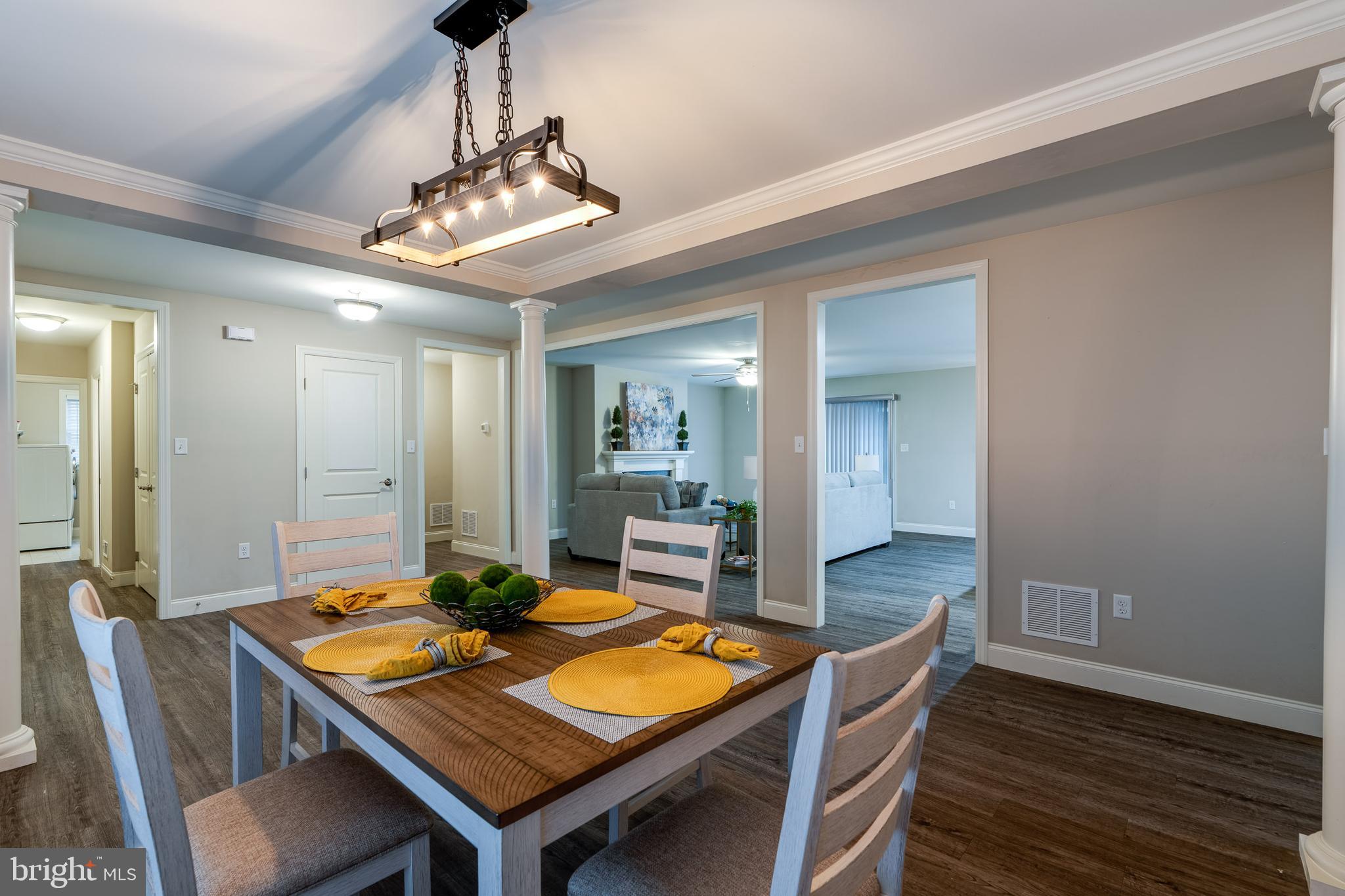 1400 Limestone Ridge Landisville, PA 17538 - Photo 49 of 50 a dining room with wooden floor a chandelier a wooden table and chairs