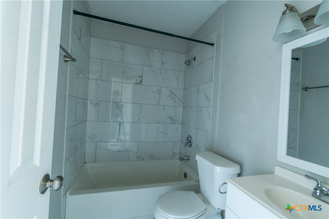 512 Sunset Lane, Unit AD Copperas Cove, TX 76522 - Photo 15 of 23 a white toilet sitting next to a bath tub and shower