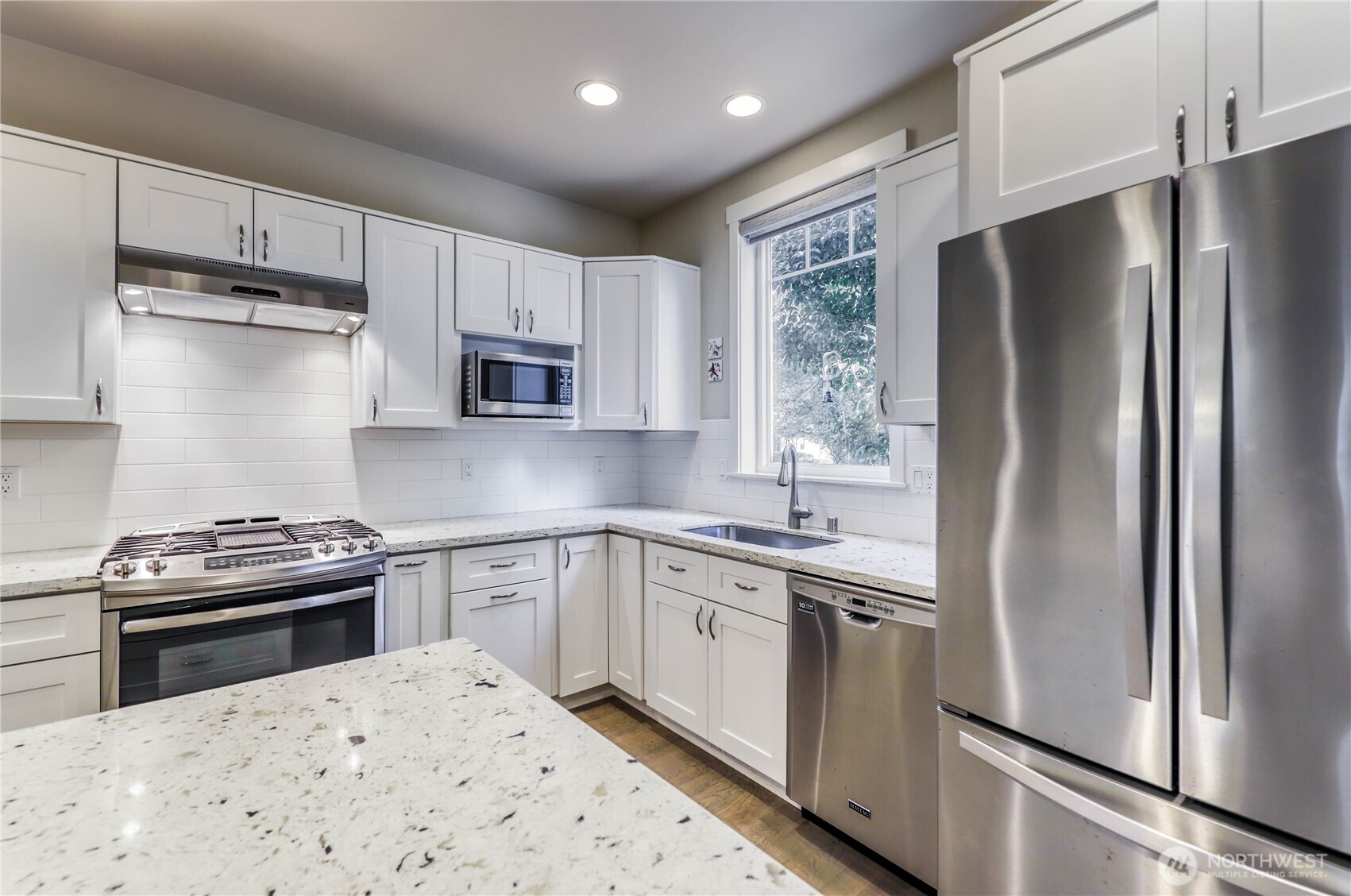 690 Wintersweet Road Northeast Bainbridge Island, WA 98110 - Photo 10 of 23 a kitchen with a stove sink and refrigerator