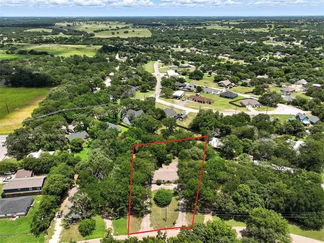a view of a city with lush green forest