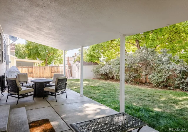 a backyard of a house with yard and outdoor seating