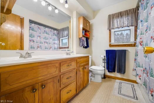 4618 South Arlington Road Uniontown, OH 44685 - Photo 26 of 31 Bathroom with toilet, tile flooring, large vanity, and dual sinks
