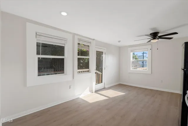 a kitchen with stainless steel appliances a refrigerator and a ceiling fan