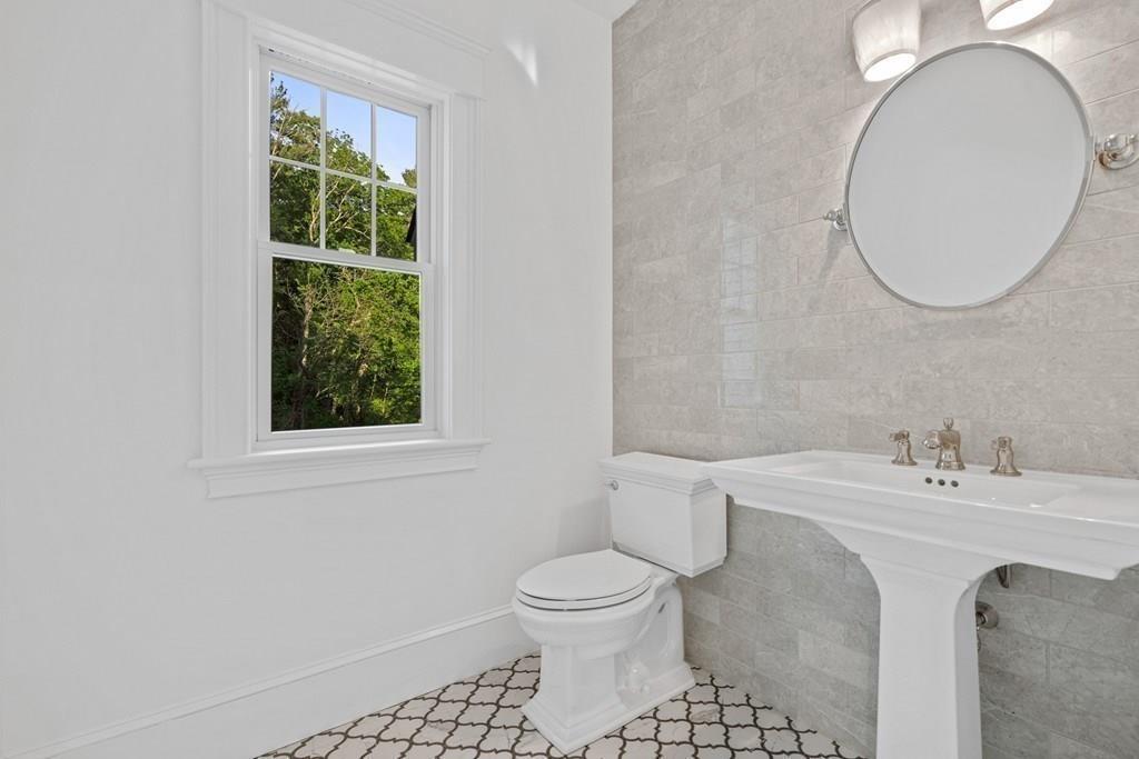 432 South Border Road Winchester, MA 01890 - Photo 19 of 40 a bathroom with a sink a toilet and a mirror