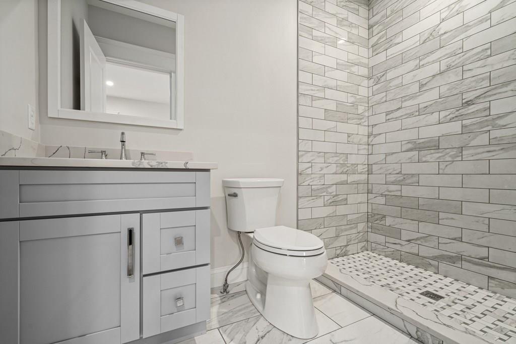 432 South Border Road Winchester, MA 01890 - Photo 22 of 40 a bathroom with a toilet sink and mirror