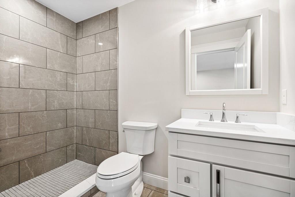 432 South Border Road Winchester, MA 01890 - Photo 24 of 40 a bathroom with a sink a toilet and a mirror
