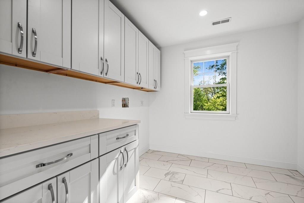 432 South Border Road Winchester, MA 01890 - Photo 35 of 40 a kitchen with white cabinets and a window