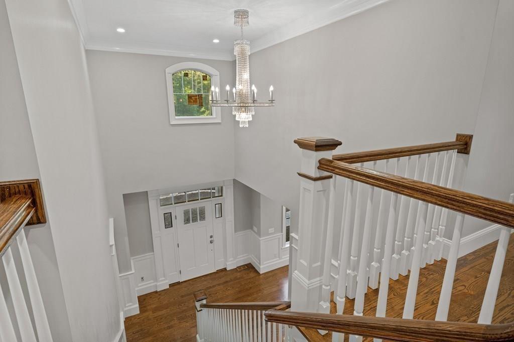 432 South Border Road Winchester, MA 01890 - Photo 6 of 40 a view of staircase with railing and a chandelier