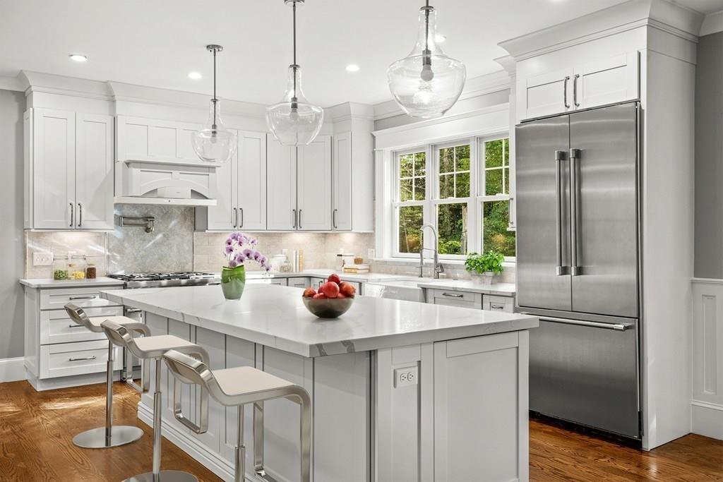 432 South Border Road Winchester, MA 01890 - Photo 7 of 40 a kitchen with stainless steel appliances a sink a window and chairs