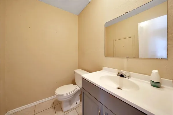 a bathroom with a sink a toilet and mirror