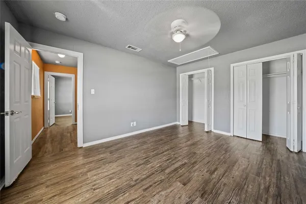 a view of empty room with wooden floor