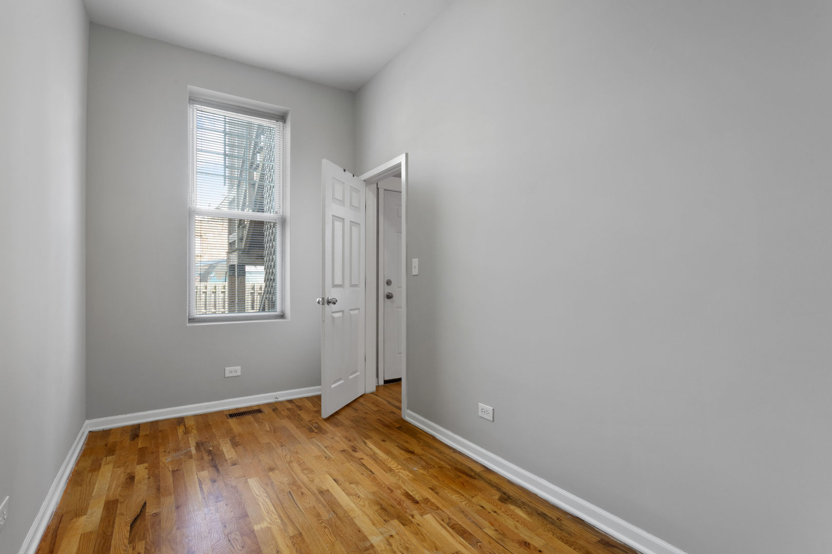 1532 West 18th Place, Unit 1R Chicago, IL 60608 - Photo 12 of 12 a view of room with window and wooden floor