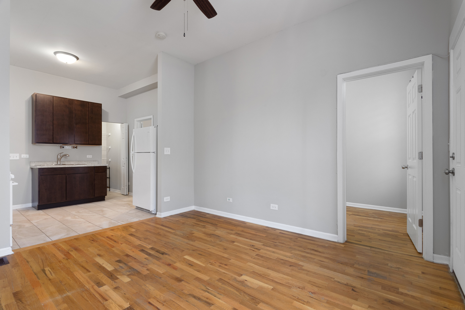 1532 West 18th Place, Unit 1R Chicago, IL 60608 - Photo 3 of 12 a bedroom with a bed and a flat screen tv