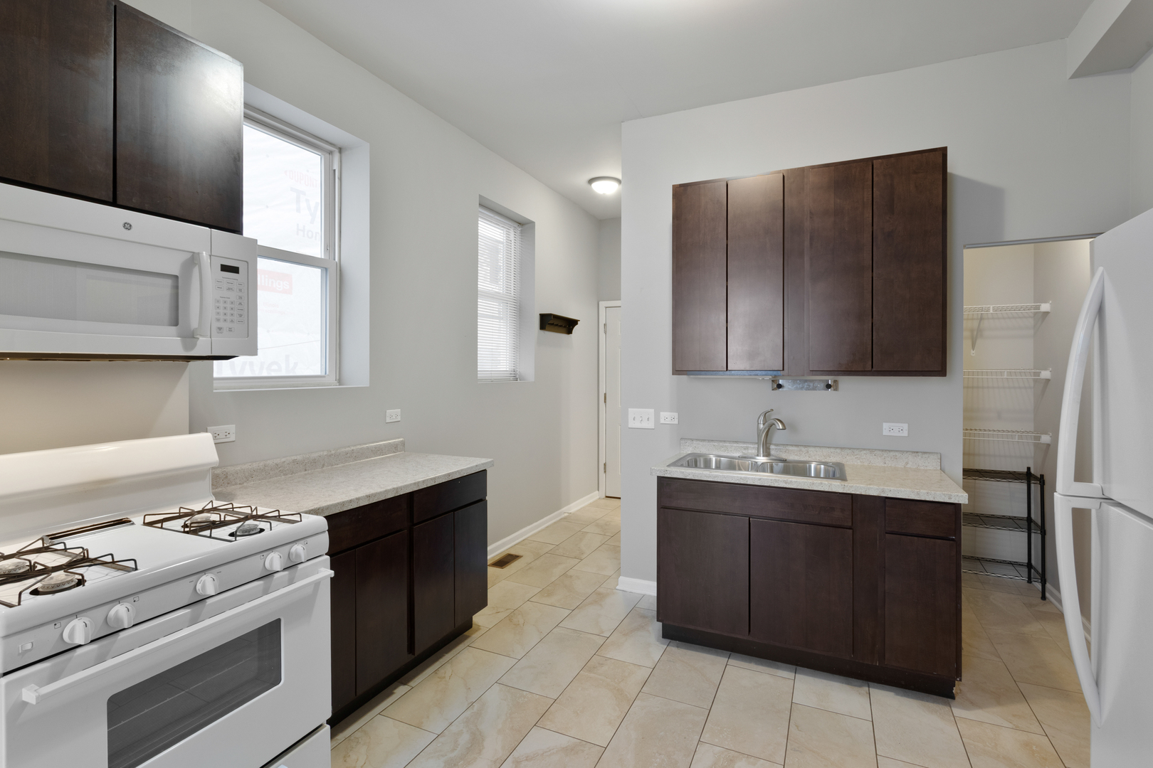 1532 West 18th Place, Unit 1R Chicago, IL 60608 - Photo 4 of 12 a kitchen with stainless steel appliances granite countertop a sink stove and refrigerator