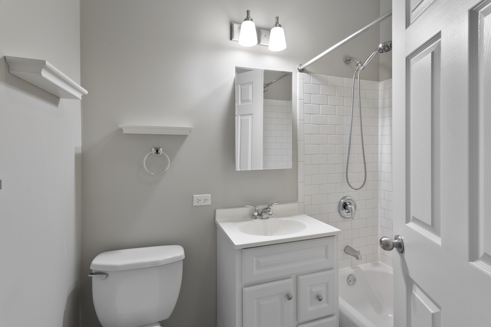 1532 West 18th Place, Unit 1R Chicago, IL 60608 - Photo 6 of 12 a bathroom with a toilet sink and mirror