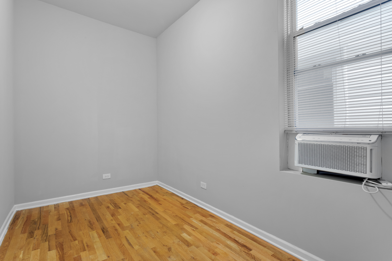 1532 West 18th Place, Unit 1R Chicago, IL 60608 - Photo 7 of 12 a view of empty room with wooden floor
