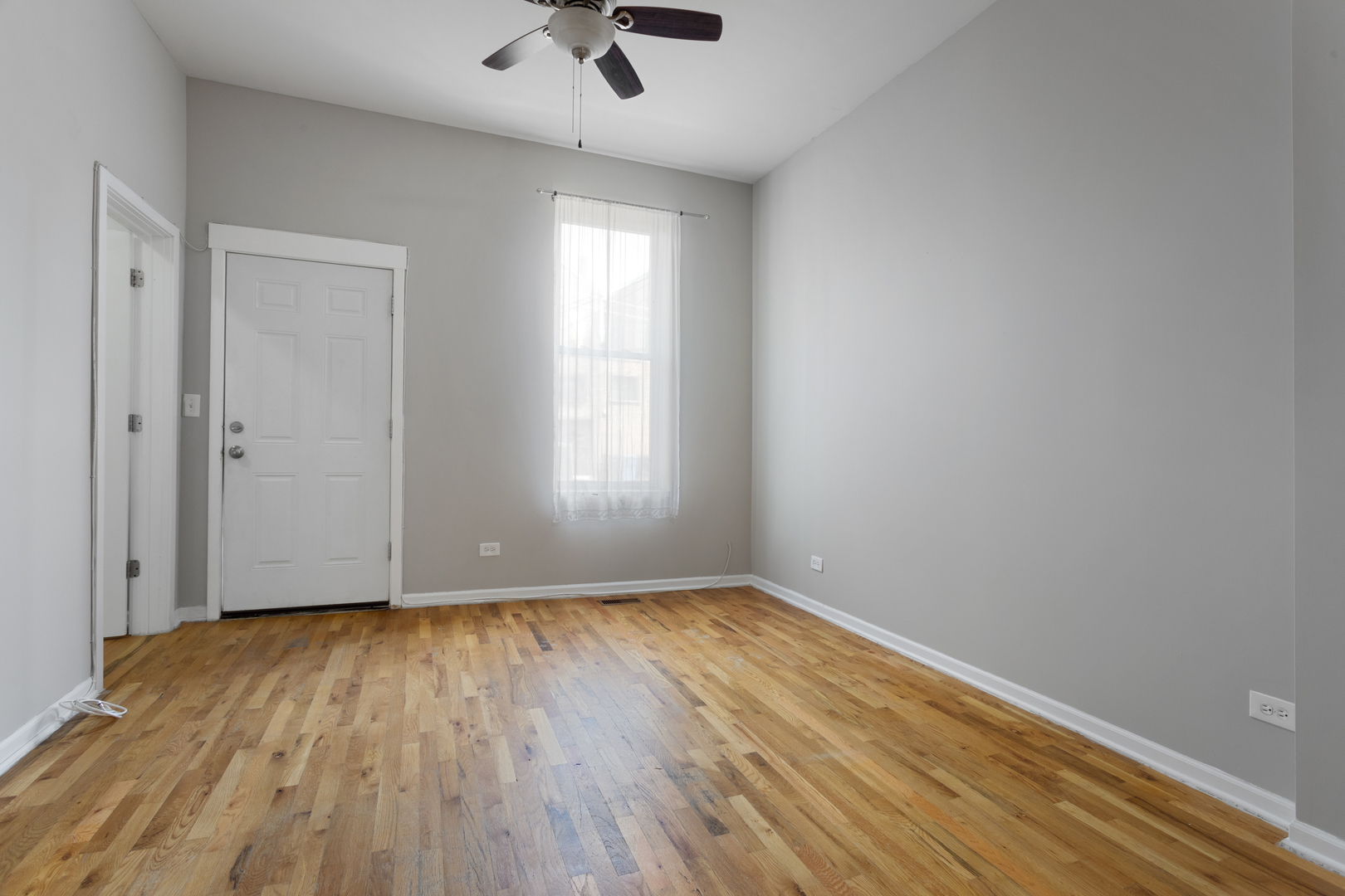 1532 West 18th Place, Unit 1R Chicago, IL 60608 - Photo 9 of 12 wooden floor in an empty room with a window
