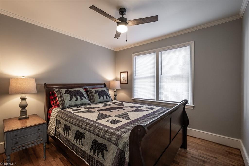 444 Elk Spur Street Elkin, NC 28621 - Photo 11 of 21 One of three bedrooms with ceiling fan and hardwood floor