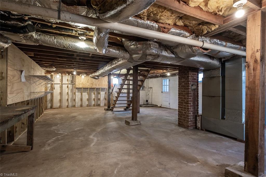 444 Elk Spur Street Elkin, NC 28621 - Photo 18 of 21 Ample storage in unfinished basement with interior and exterior entrances.