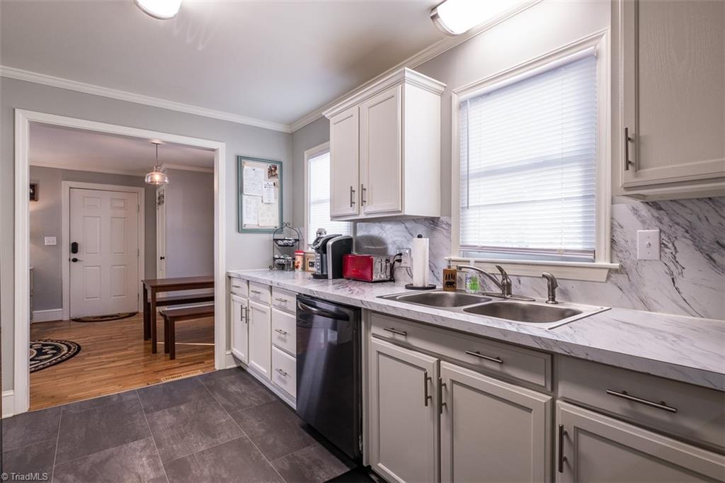 444 Elk Spur Street Elkin, NC 28621 - Photo 6 of 21 Updated kitchen with white cabinets and vinyl flooring.