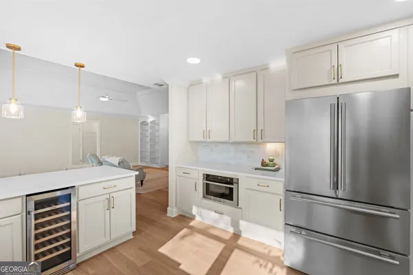 a view of a kitchen with microwave and cabinets