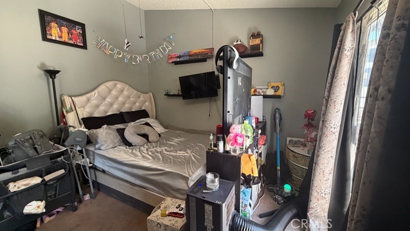2478 KOA Drive Rialto, CA 92377 - Photo 6 of 18 a bedroom with a bed and wooden floor