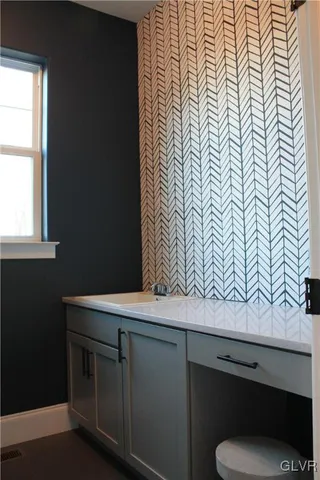 a view of cabinets with a sink and wooden floor