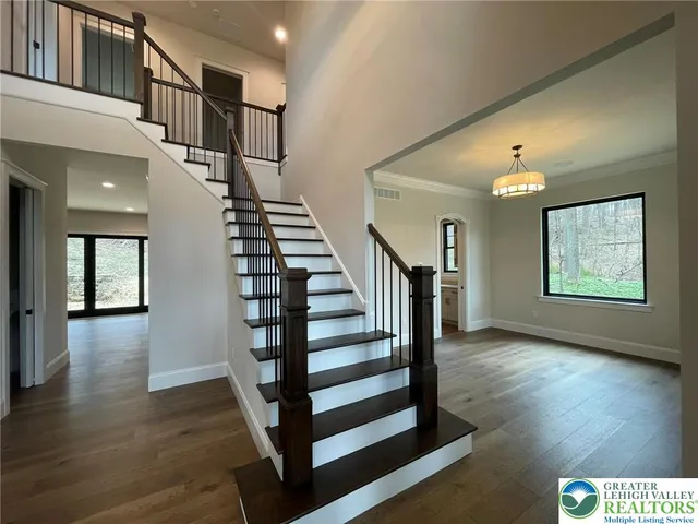 a view of entryway and hall with wooden floor