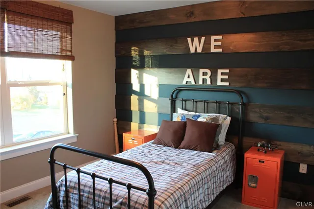 a bedroom with a bed and window