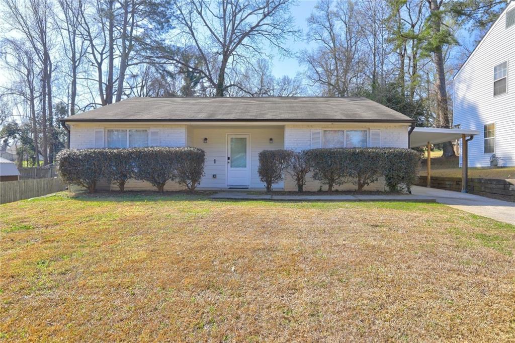 3480 Meadowlane Circle Southwest Atlanta, GA 30331 - Photo 1 of 1 a front view of house with yard and trees in the background